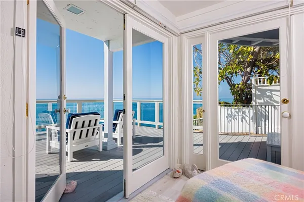 a bedroom with a balcony a bed and a window