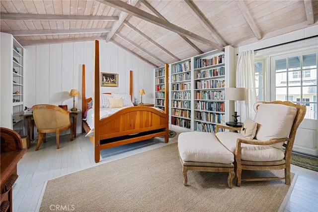a bedroom with furniture and a book shelf