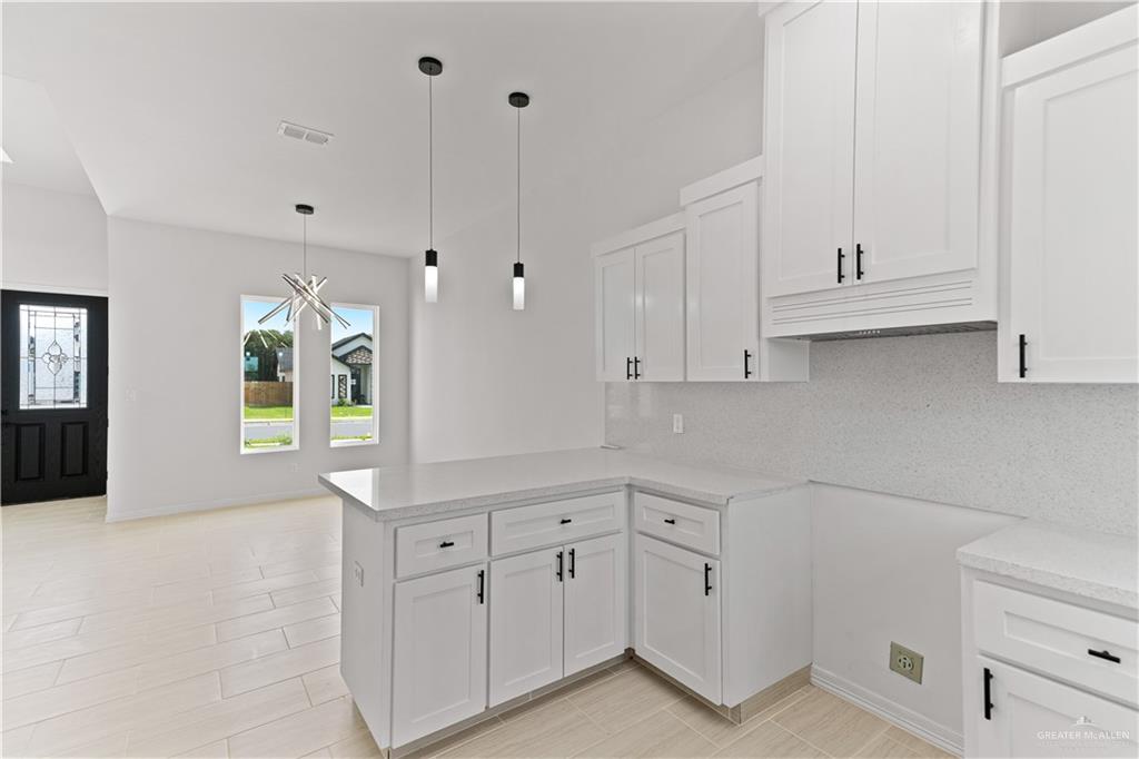 1925 Trinity Street Donna, TX 78537 - Photo 8 of 20 a kitchen with white cabinets and white appliances