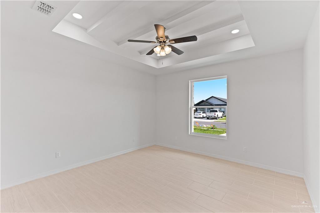 1925 Trinity Street Donna, TX 78537 - Photo 10 of 20 an empty room with windows and fan