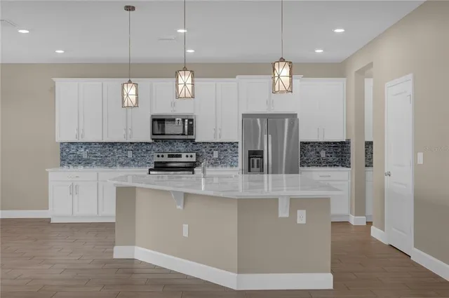 a view of kitchen with furniture and wooden floor