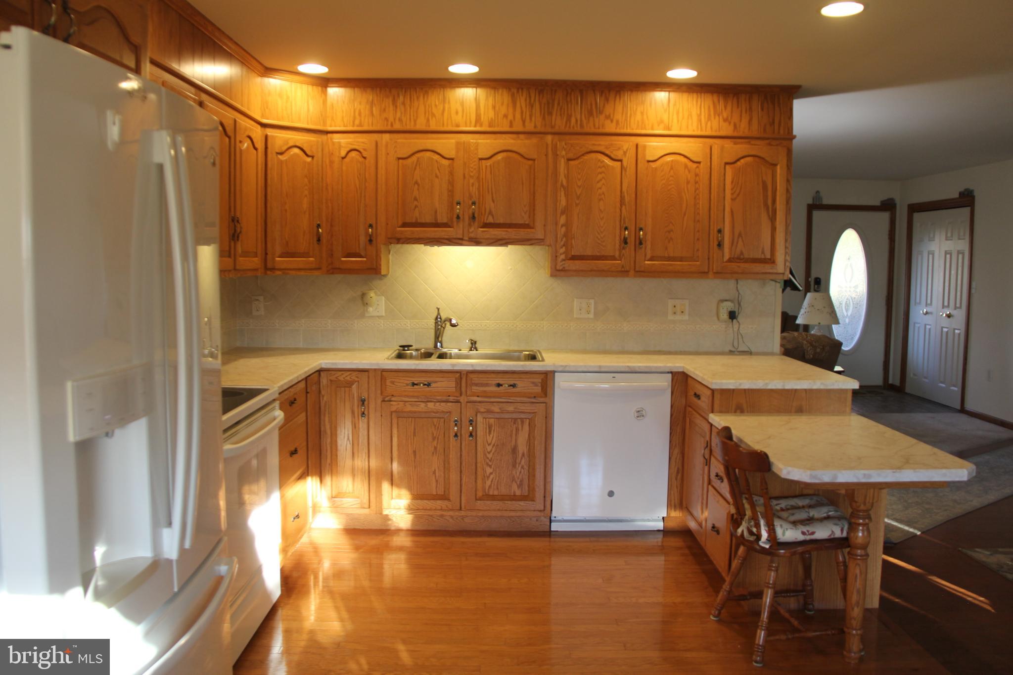 668 Snyder Hill Road Lititz, PA 17543 - Photo 14 of 32 a kitchen with a table chairs refrigerator and cabinets
