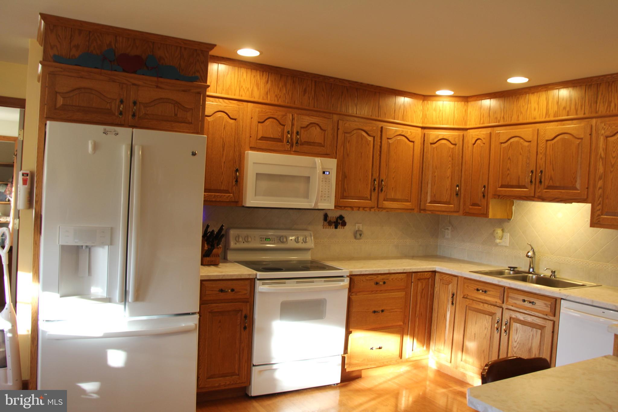 668 Snyder Hill Road Lititz, PA 17543 - Photo 16 of 32 a kitchen with stainless steel appliances granite countertop a sink a stove and a refrigerator