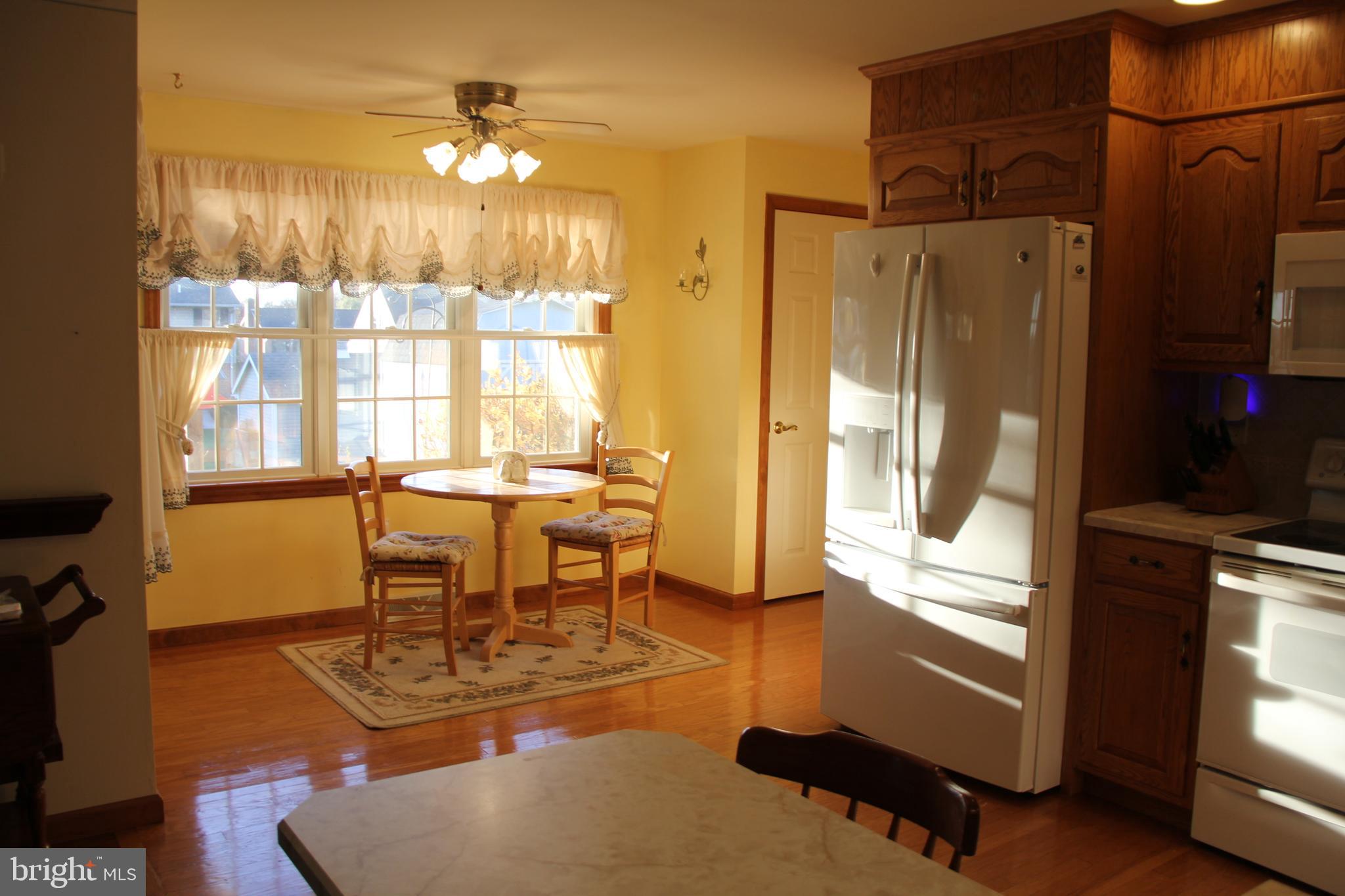 668 Snyder Hill Road Lititz, PA 17543 - Photo 18 of 32 a dining room with furniture a chandelier and wooden floor