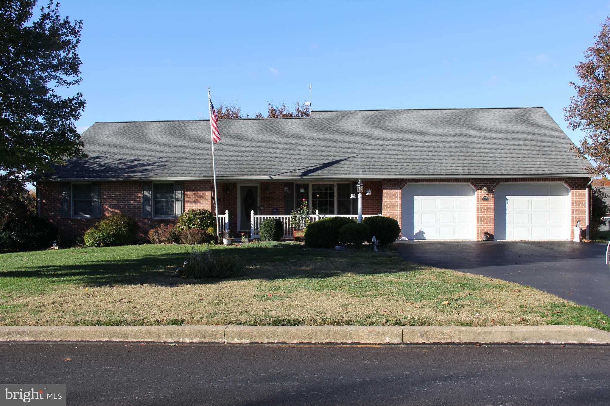 668 Snyder Hill Road Lititz, PA 17543 - Photo 6 of 32 a front view of a house with a yard and garage