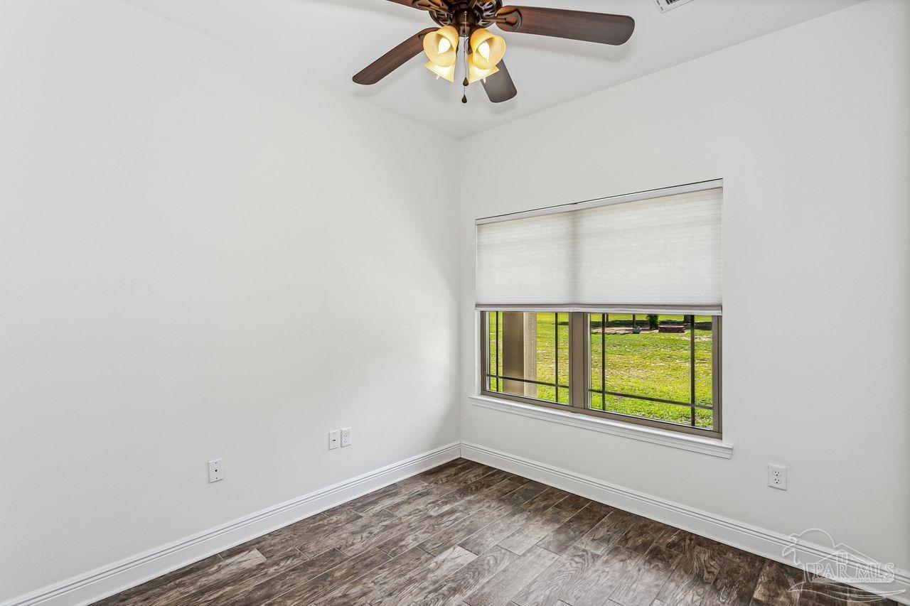 5201 Mayburn Bridge Road Milton, FL 32570 - Photo 18 of 41 an empty room with a window and a ceiling fan