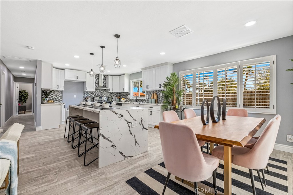 373 East Simms Road Palm Springs, CA 92262 - Photo 16 of 24 a view of a dining room with furniture window and wooden floor