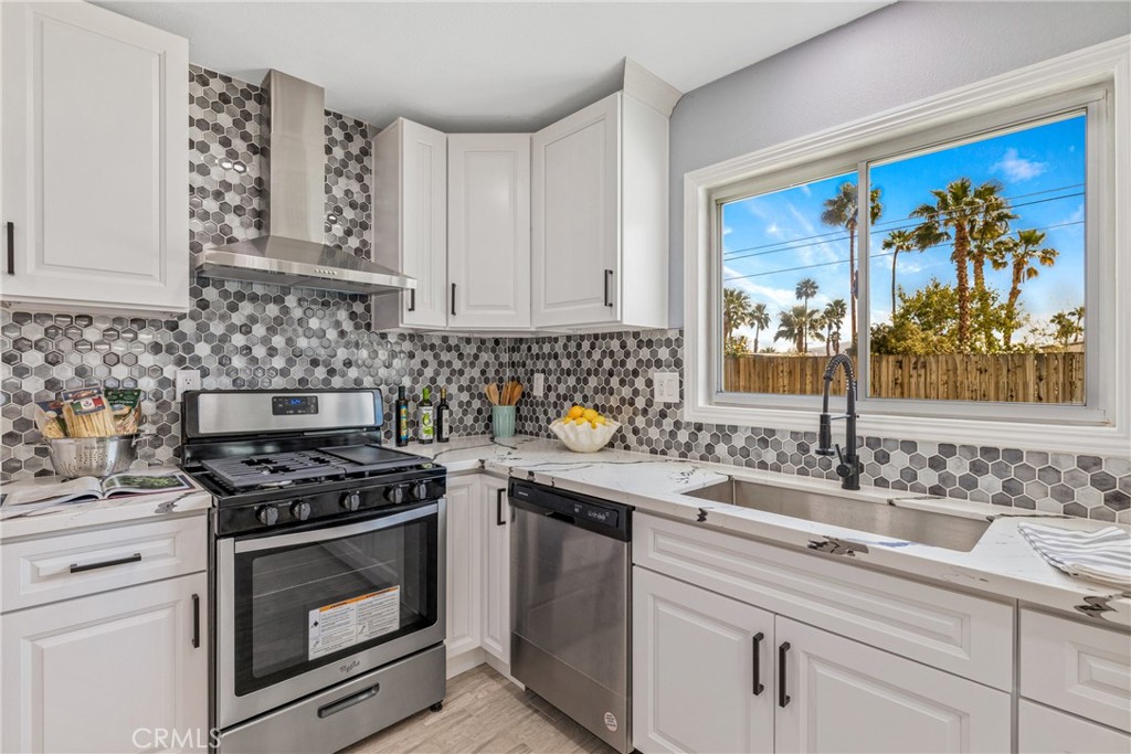 373 East Simms Road Palm Springs, CA 92262 - Photo 19 of 24 a kitchen with stainless steel appliances a stove sink and cabinets