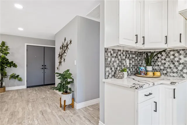 a kitchen with granite countertop cabinets and potted plant