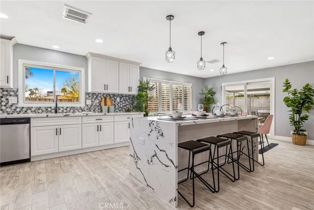a kitchen with center island and chairs