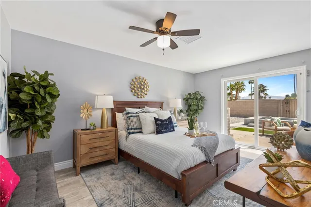 a bedroom with a bed table flowerpot and window