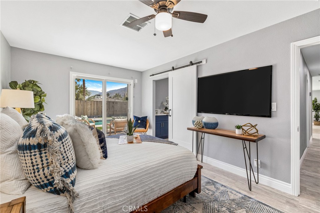 373 East Simms Road Palm Springs, CA 92262 - Photo 5 of 24 a bedroom with a bed and a flat screen tv