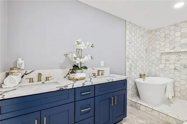 a bathroom with a double vanity sink and a mirror