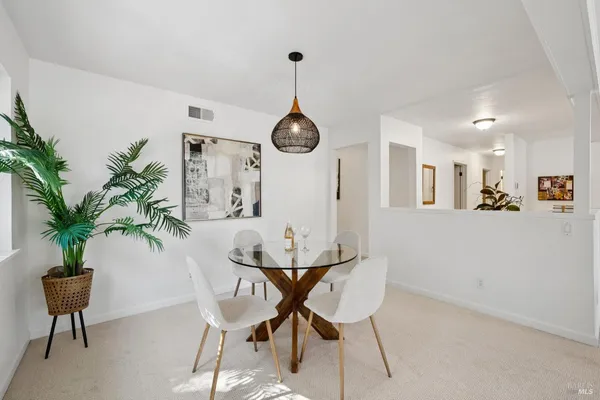 a dining room with furniture window and wooden floor