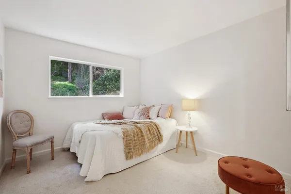 a bathroom with a sink a potted plant and a window