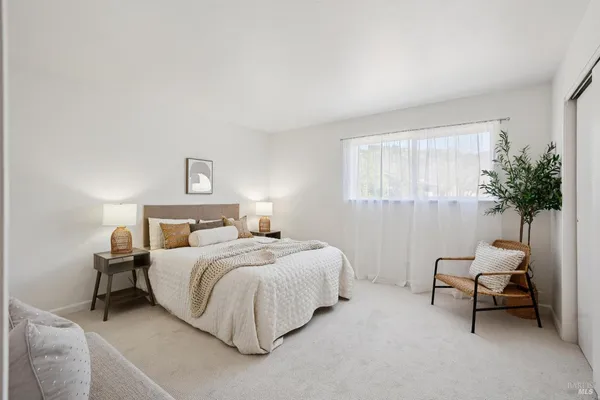 a bedroom with a bed and a lamp