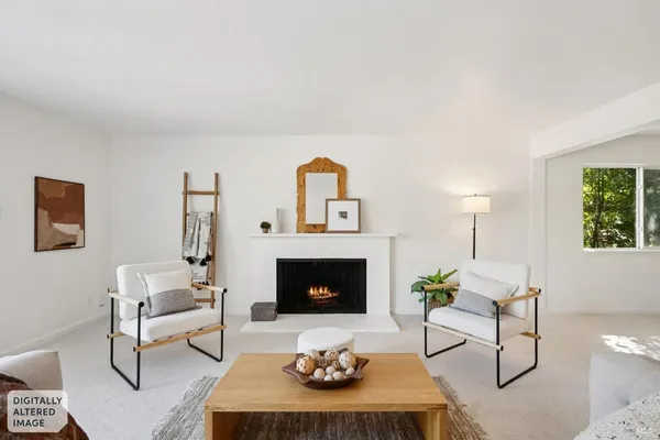 a living room with furniture a rug and a fireplace