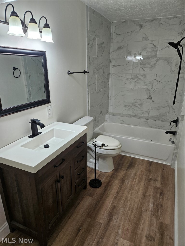 753 West River Road North Elyria, OH 44035 - Photo 10 of 28 Bathroom featuring a wood-finish vanity with a white countertop, an undermount sink, a framed mirror, and a three-light fixture