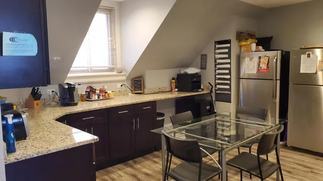a kitchen with a table chairs and a refrigerator