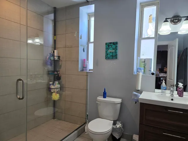 a bathroom with a toilet sink and shower