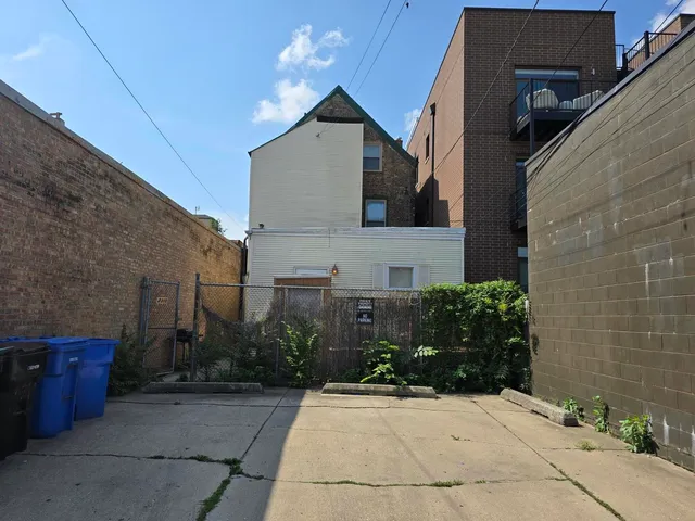 a view of a house with brick walls and potted plants