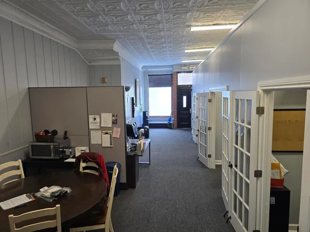 a room with furniture and a view of bedroom