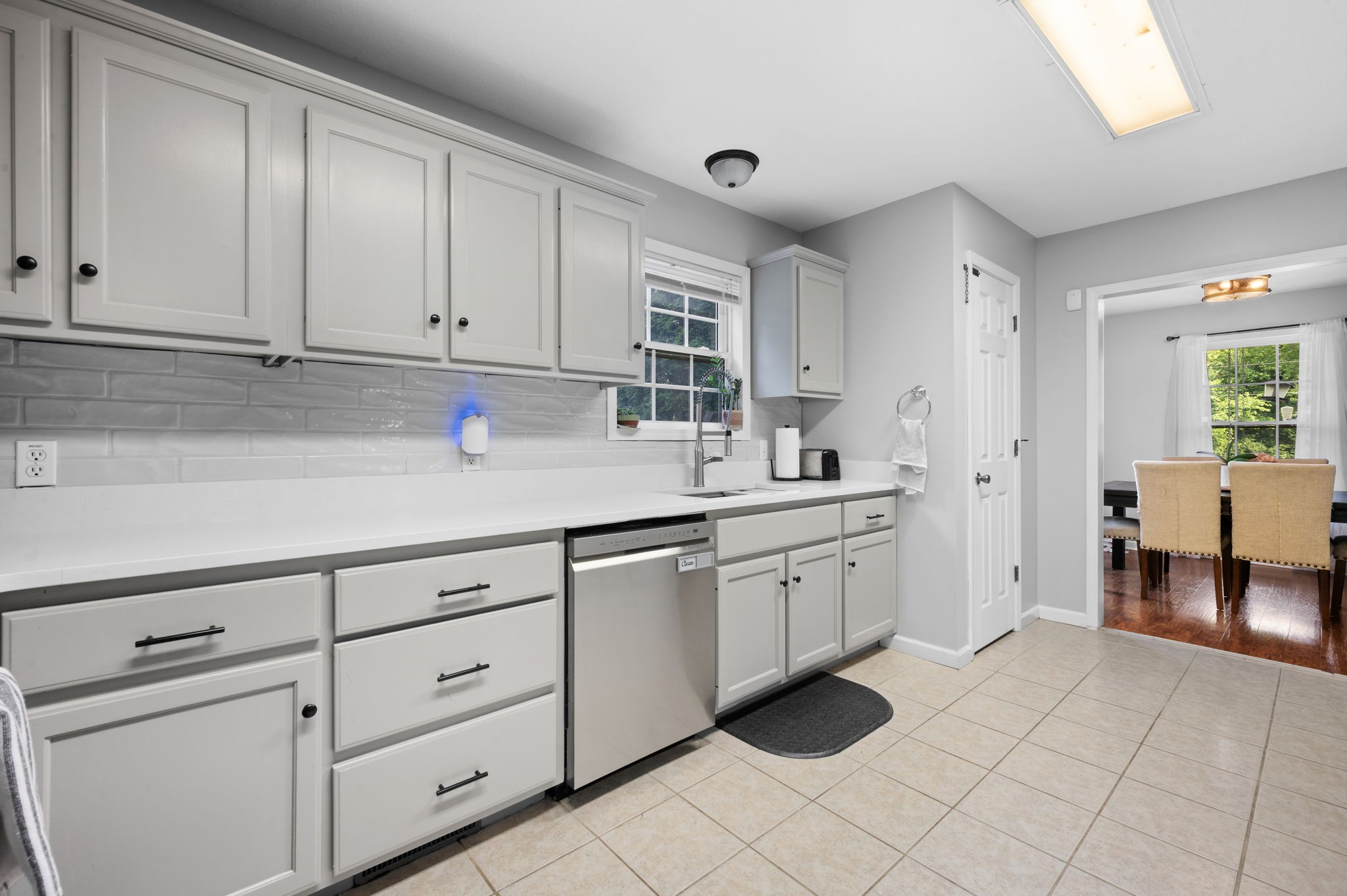 1197 Biter Road Cunningham, TN 37052 - Photo 10 of 38 a kitchen with white cabinets a sink and dishwasher