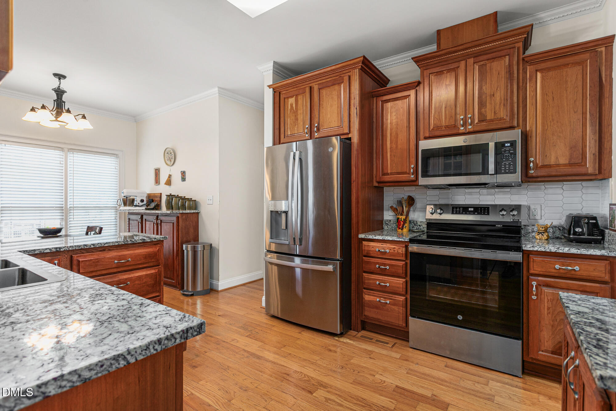 7 Powder Springs Place Durham, NC 27712 - Photo 17 of 44 a kitchen with stainless steel appliances granite countertop a stove a refrigerator and a sink