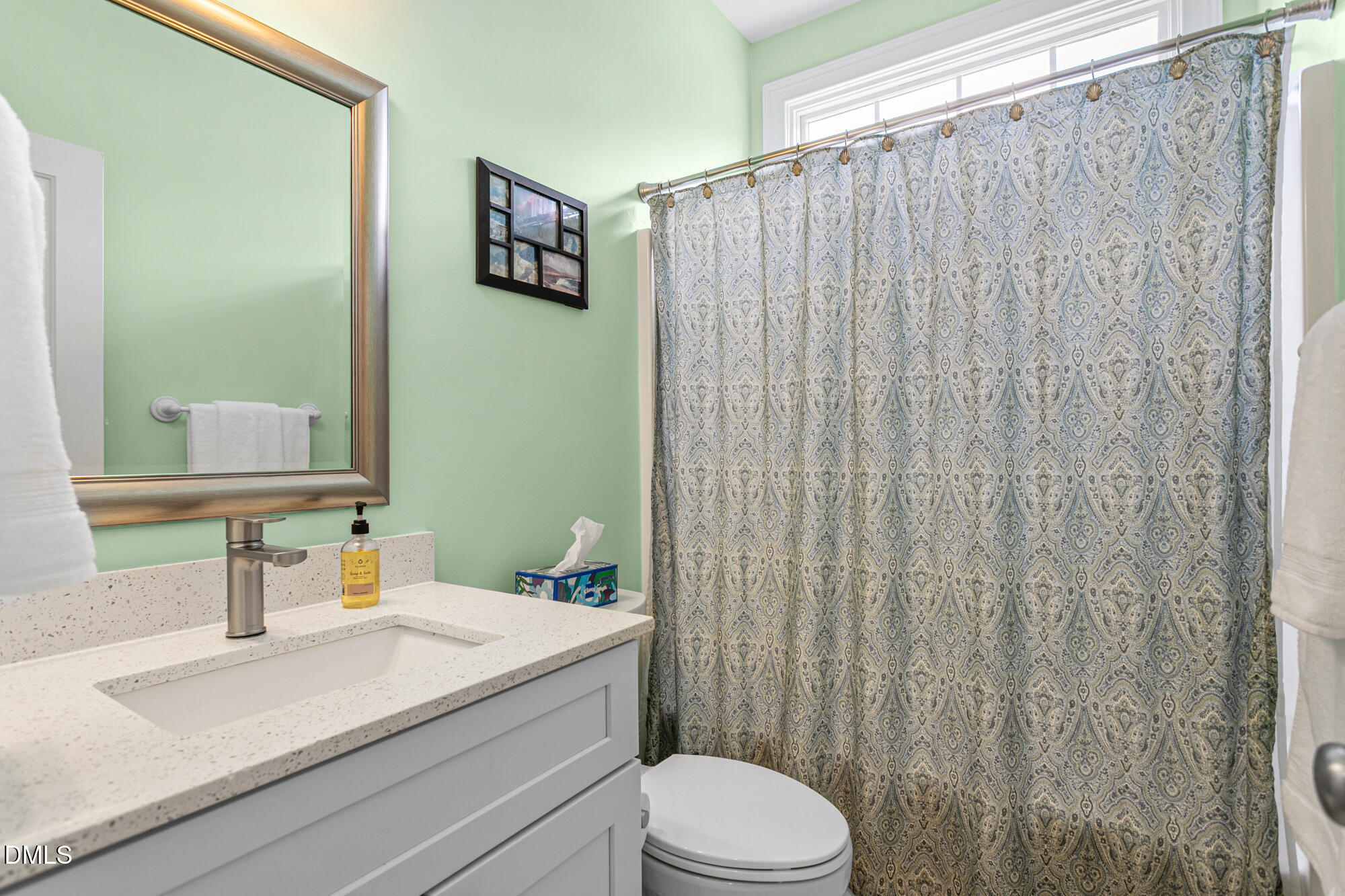 7 Powder Springs Place Durham, NC 27712 - Photo 22 of 44 a bathroom with a sink a toilet and shower curtain