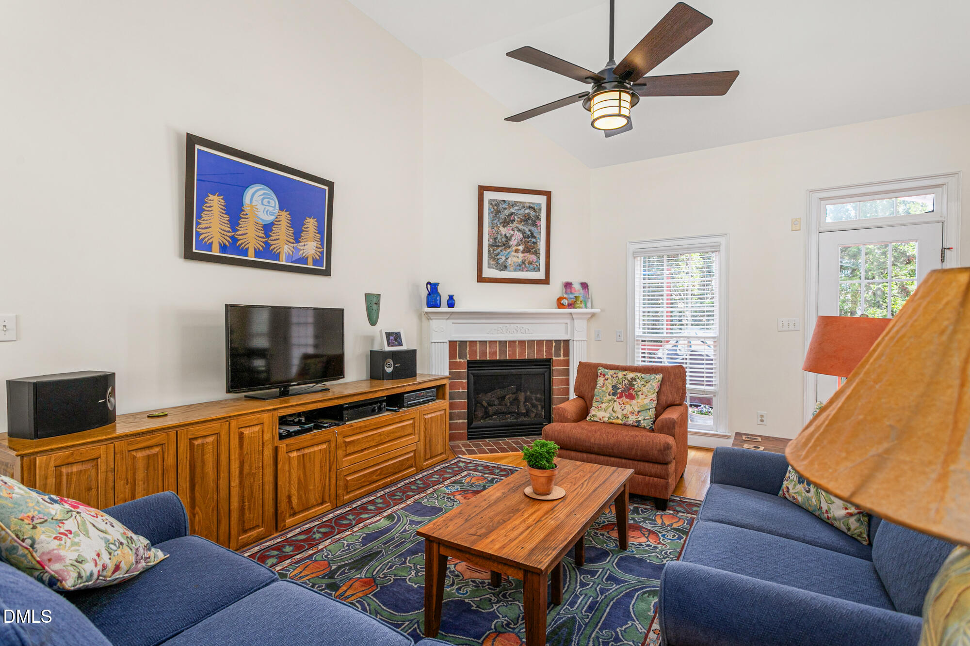7 Powder Springs Place Durham, NC 27712 - Photo 10 of 44 a living room with furniture a flat screen tv and a fireplace