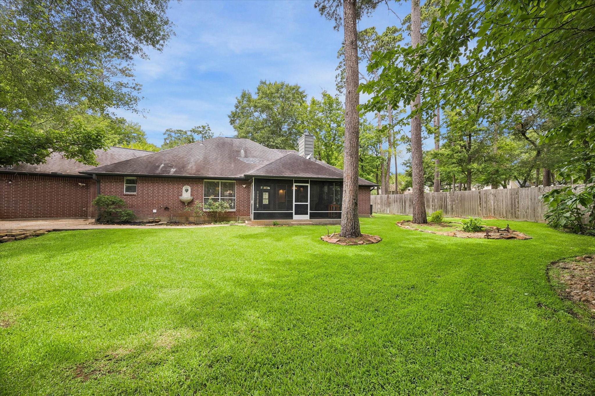 109 Dawns Edge Conroe, TX 77356 - Photo 20 of 24 a front view of a house with a yard and trees