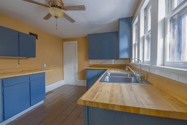 a room with wooden floors and glass door