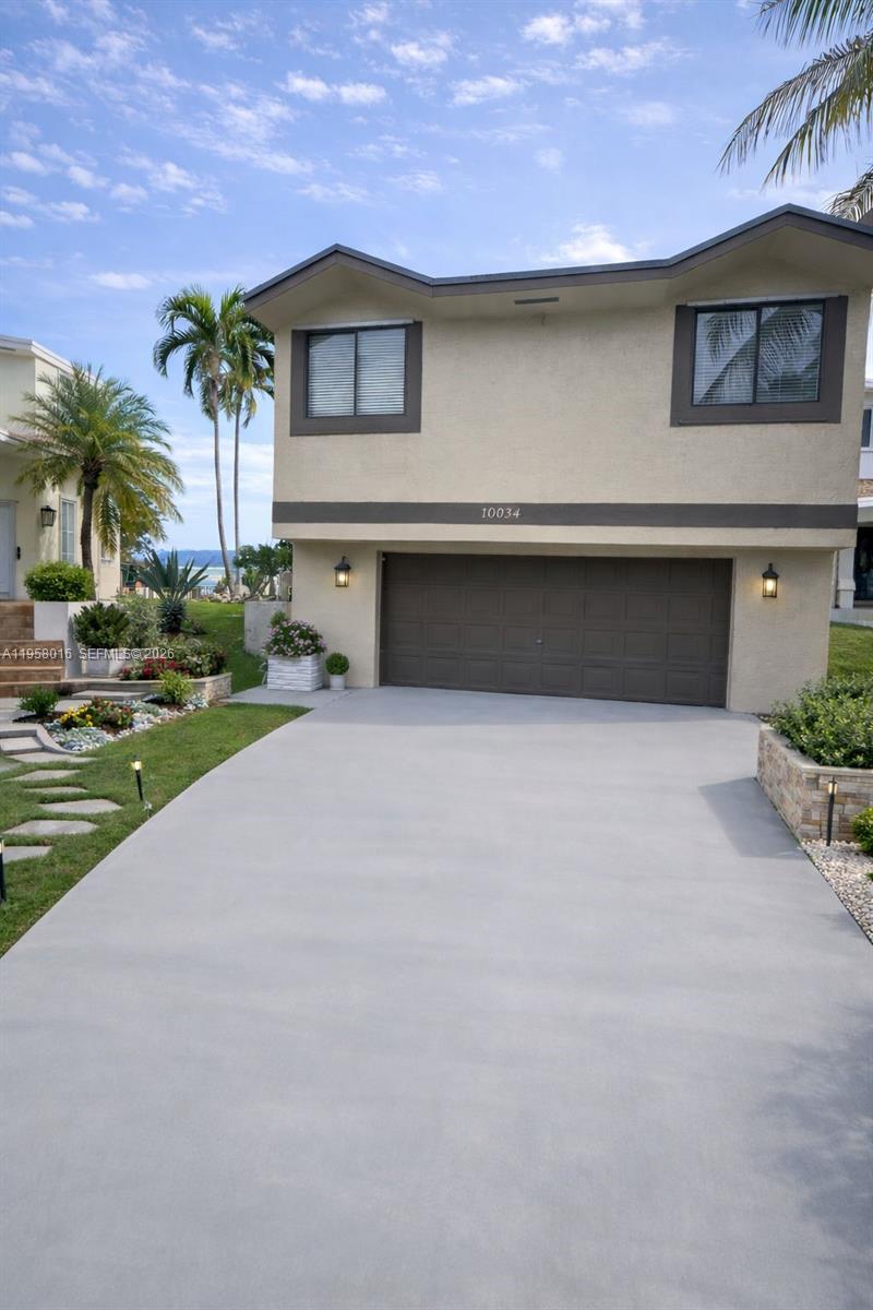 10034 Southwest 221st Street Cutler Bay, FL 33190 - Photo 1 of 25 a front view of a house with garden