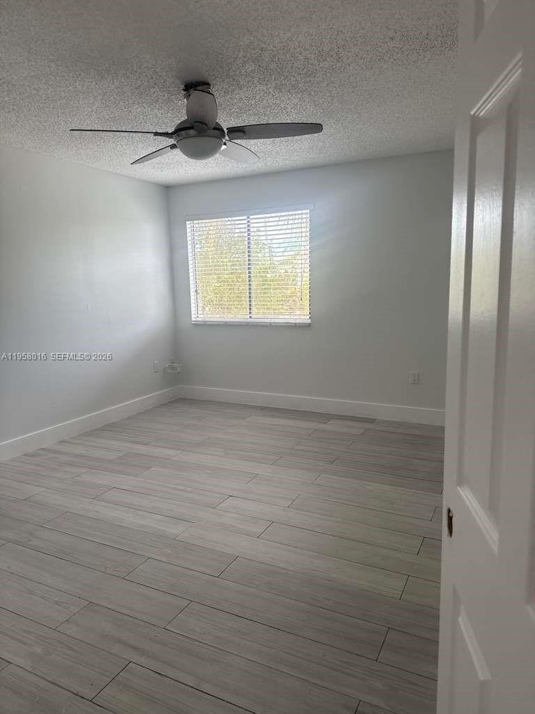 10034 Southwest 221st Street Cutler Bay, FL 33190 - Photo 14 of 25 wooden floor in an empty room