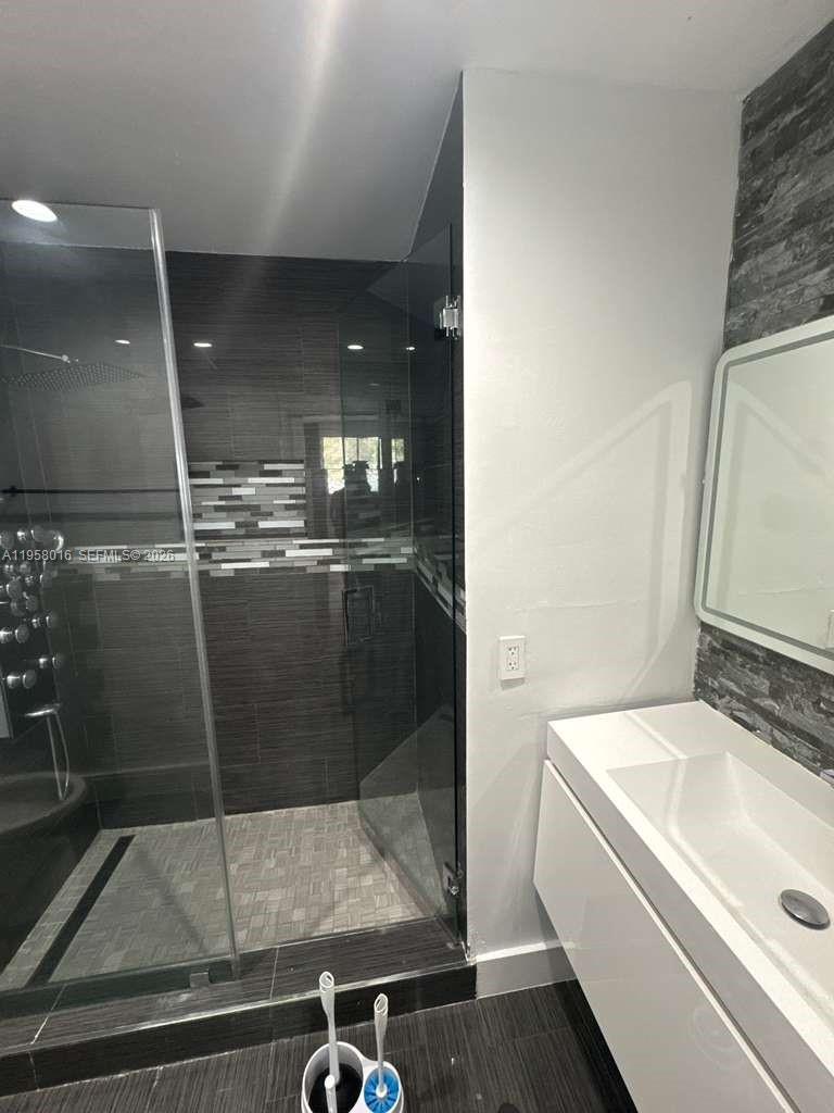 10034 Southwest 221st Street Cutler Bay, FL 33190 - Photo 16 of 25 a bathroom with a sink and mirror