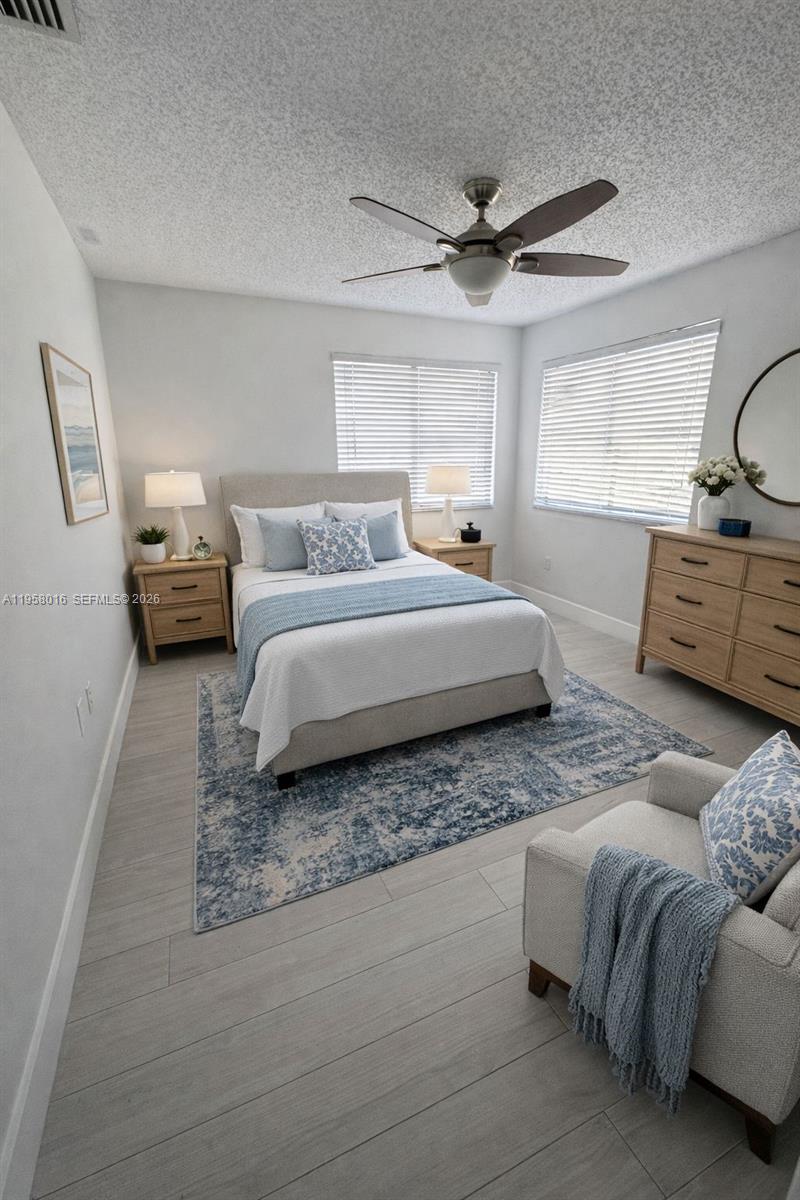 10034 Southwest 221st Street Cutler Bay, FL 33190 - Photo 17 of 25 a bedroom with bed and window