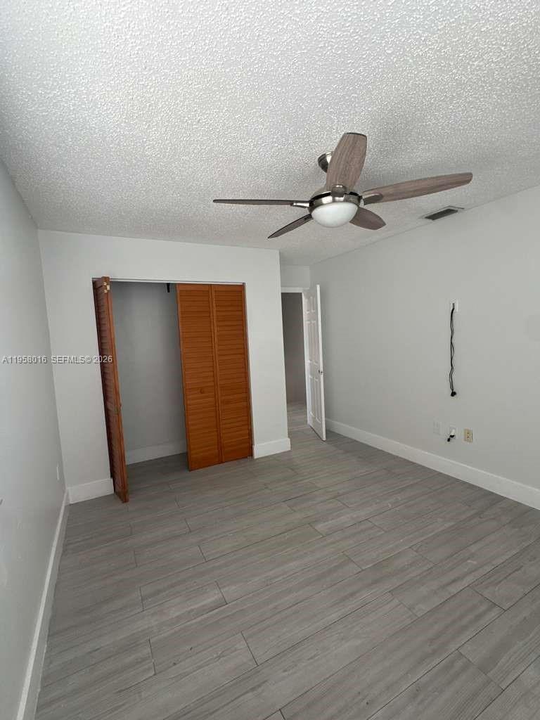 10034 Southwest 221st Street Cutler Bay, FL 33190 - Photo 19 of 25 a view of a livingroom with a ceiling fan and wooden floor