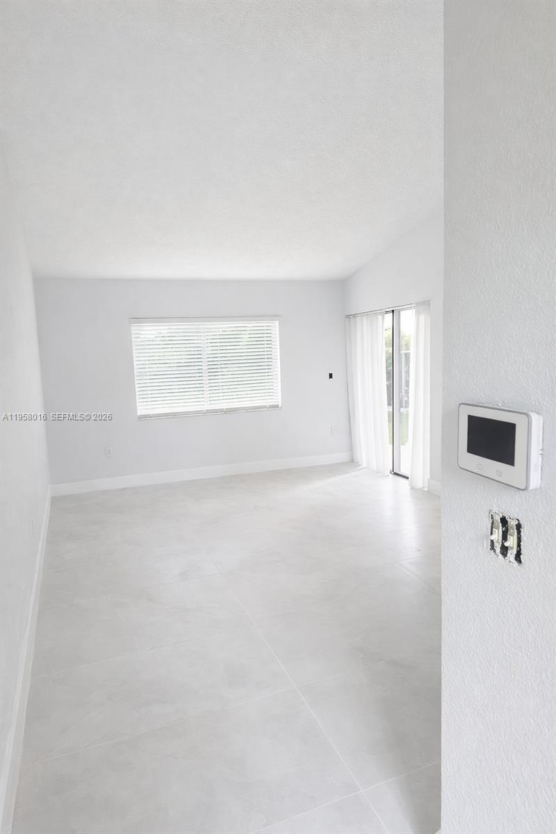 10034 Southwest 221st Street Cutler Bay, FL 33190 - Photo 2 of 25 an empty room with windows