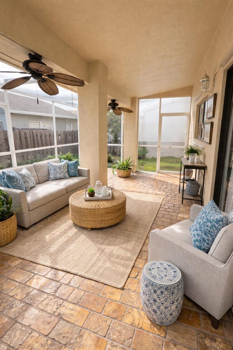 10034 Southwest 221st Street Cutler Bay, FL 33190 - Photo 9 of 25 a living room with furniture and a floor to ceiling window