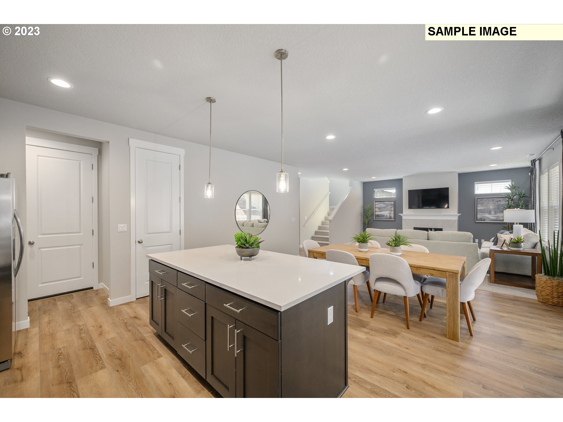41510 Metolius Avenue, Unit 16 Sandy, OR 97055 - Photo 13 of 40 a view of a dining room and livingroom with furniture wooden floor a rug a painting and a chandelier
