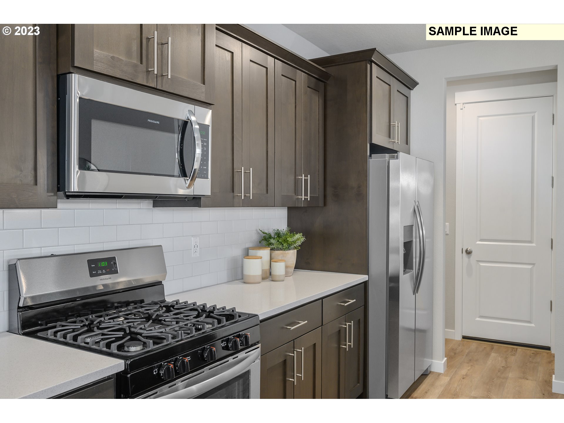 41510 Metolius Avenue, Unit 16 Sandy, OR 97055 - Photo 15 of 40 a kitchen with stainless steel appliances granite countertop a stove a microwave a refrigerator and cabinets