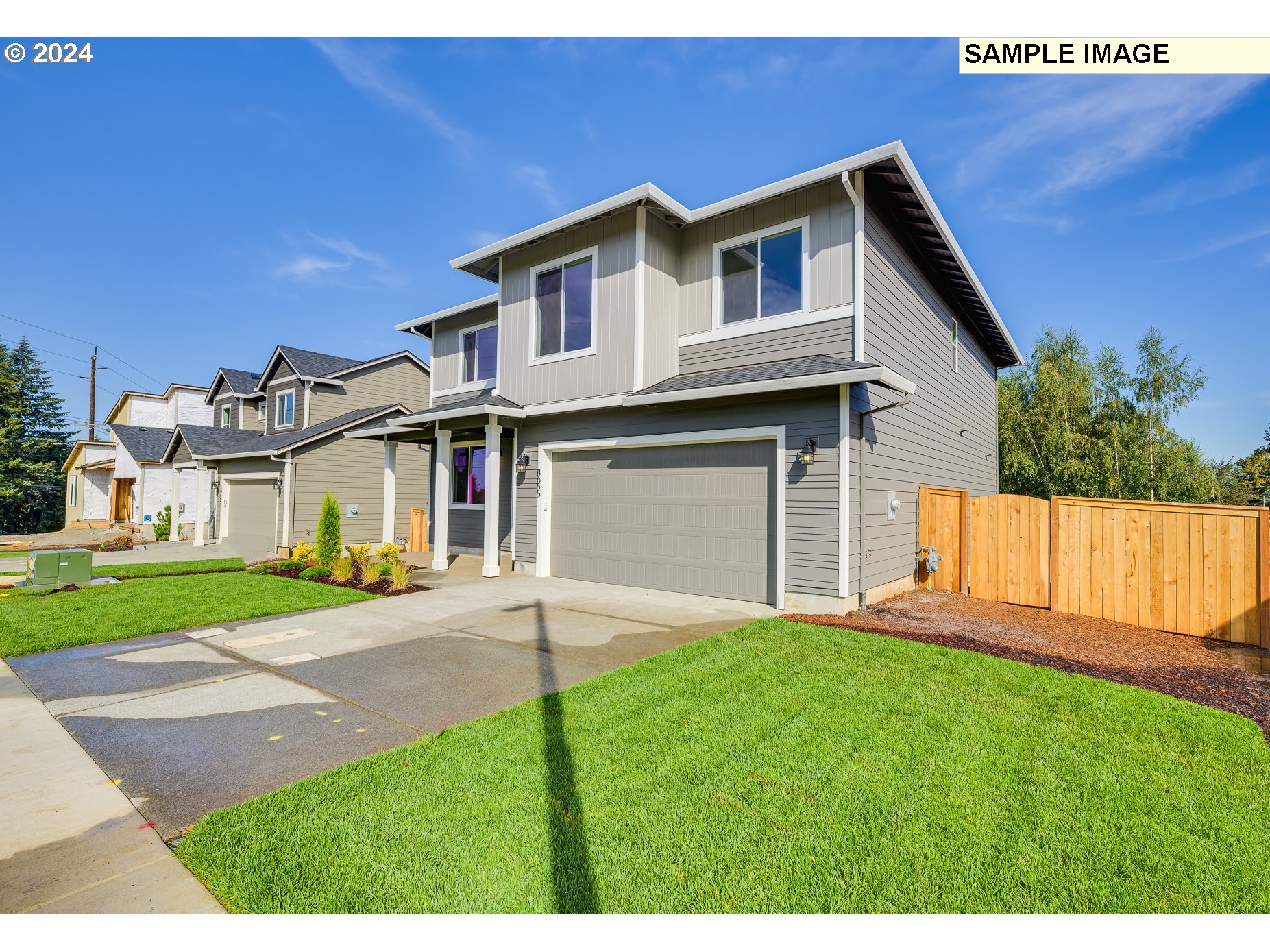 41510 Metolius Avenue, Unit 16 Sandy, OR 97055 - Photo 2 of 40 a front view of a house with a yard and garage