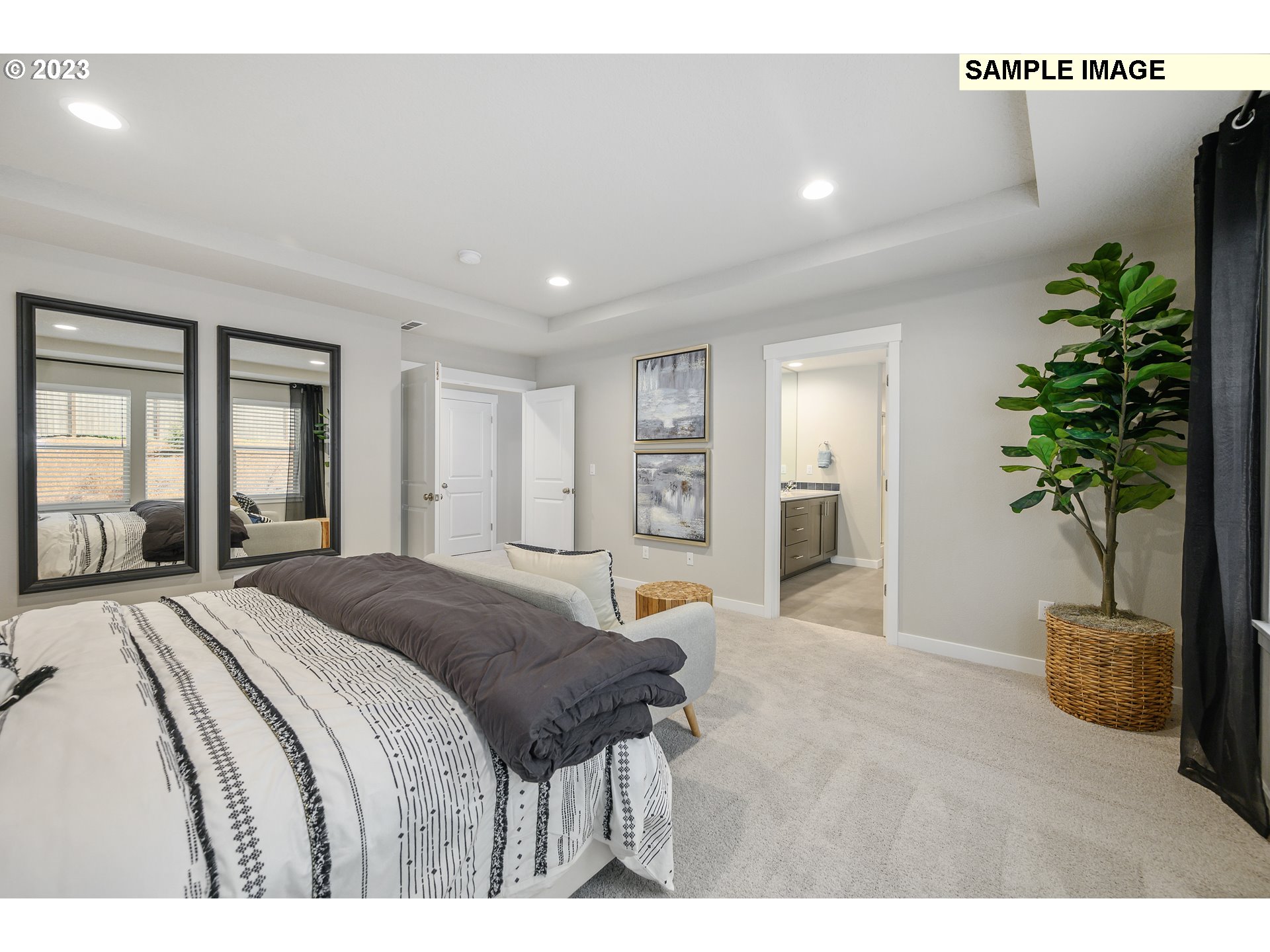 41510 Metolius Avenue, Unit 16 Sandy, OR 97055 - Photo 24 of 40 a spacious bedroom with a large bed and a potted plant
