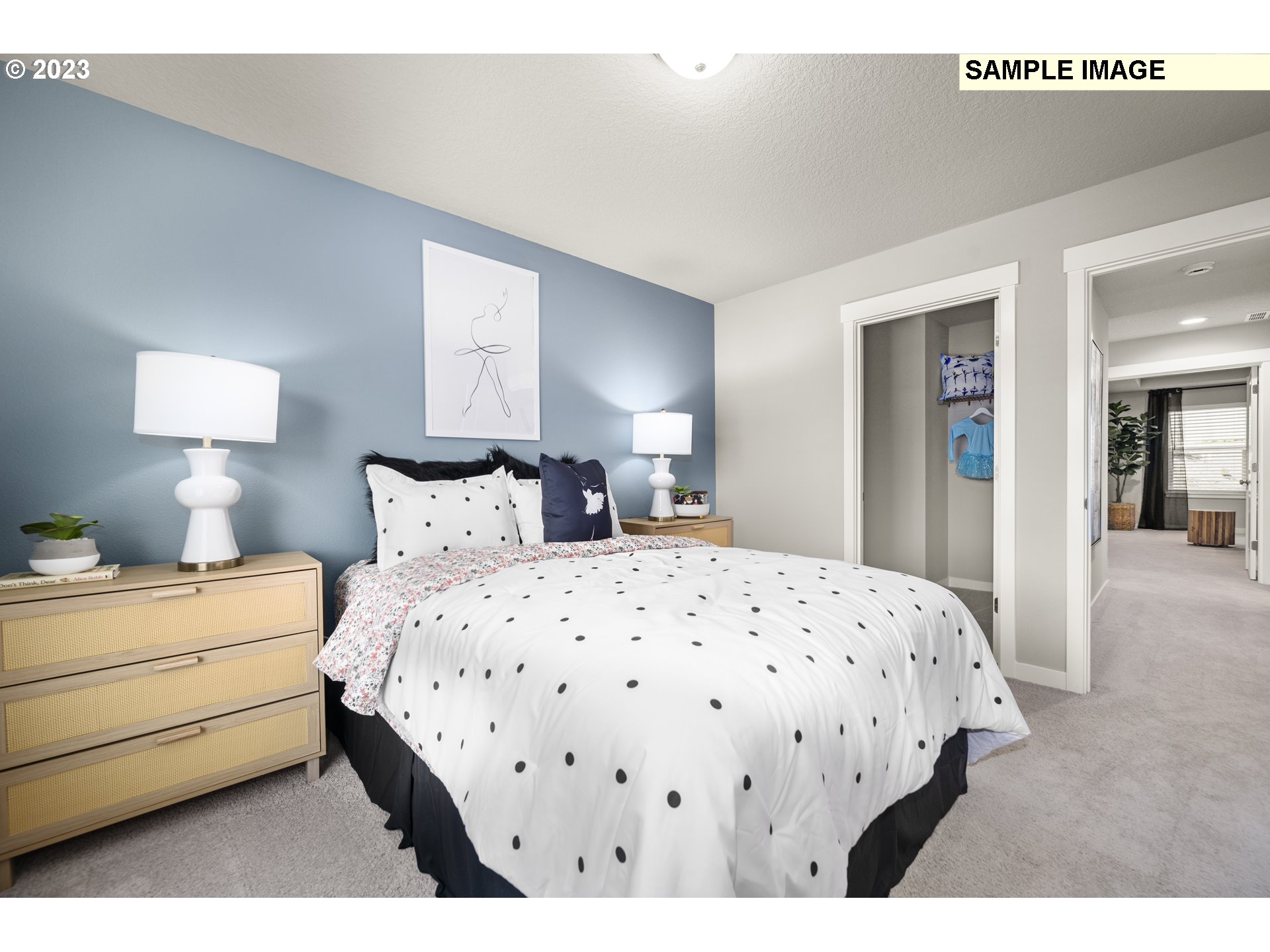 41510 Metolius Avenue, Unit 16 Sandy, OR 97055 - Photo 34 of 40 a bedroom with a bed a lamp and mirror