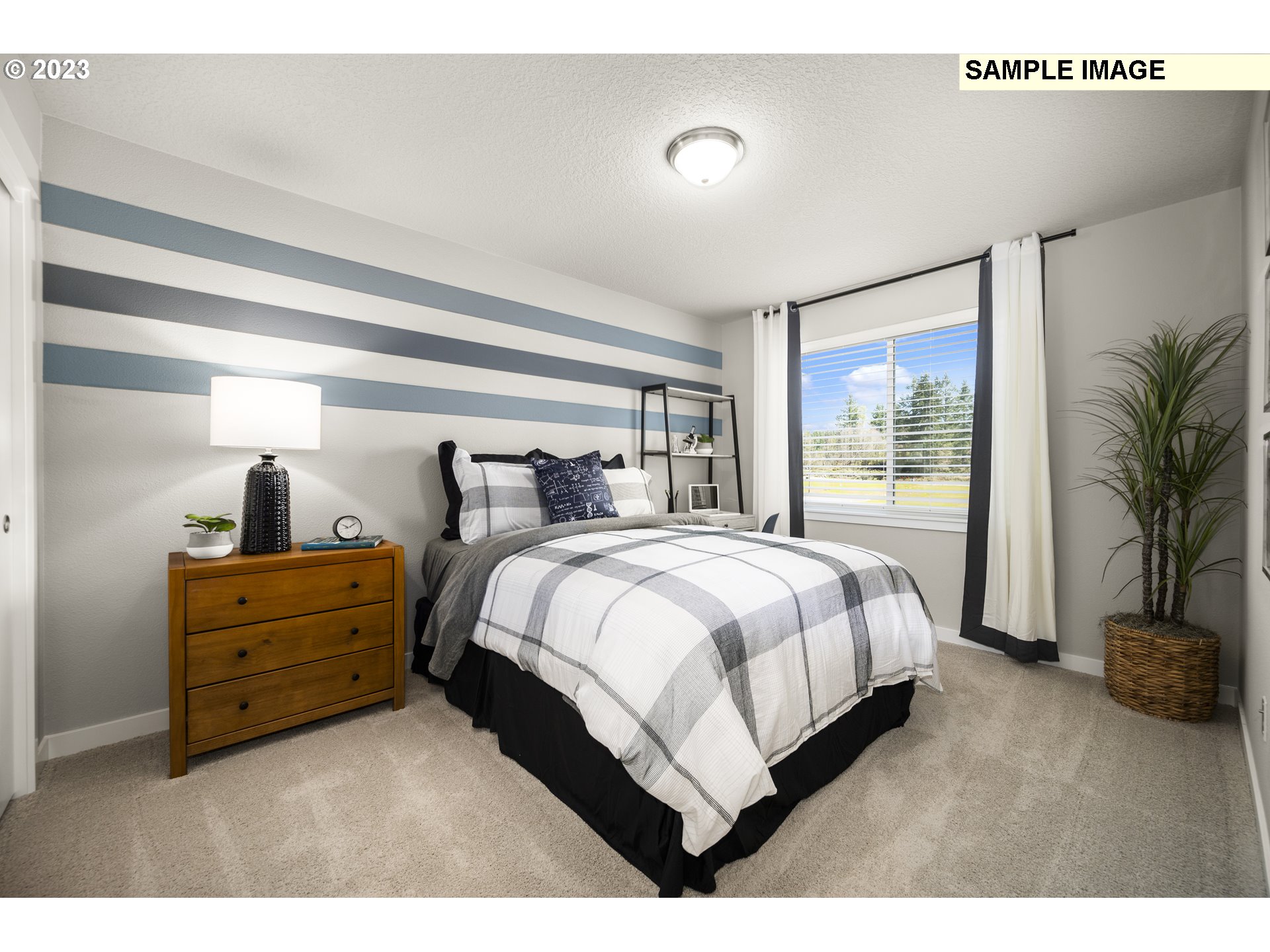 41510 Metolius Avenue, Unit 16 Sandy, OR 97055 - Photo 35 of 40 a spacious bedroom with a bed and a large window