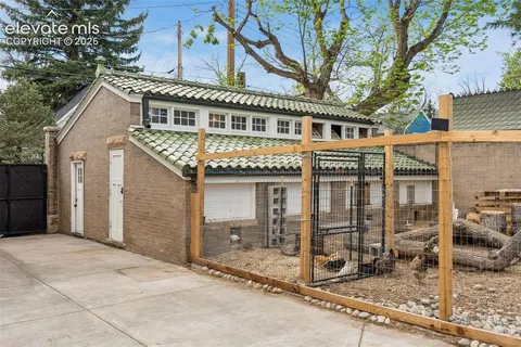 a view of a patio with wooden floor next to a yard