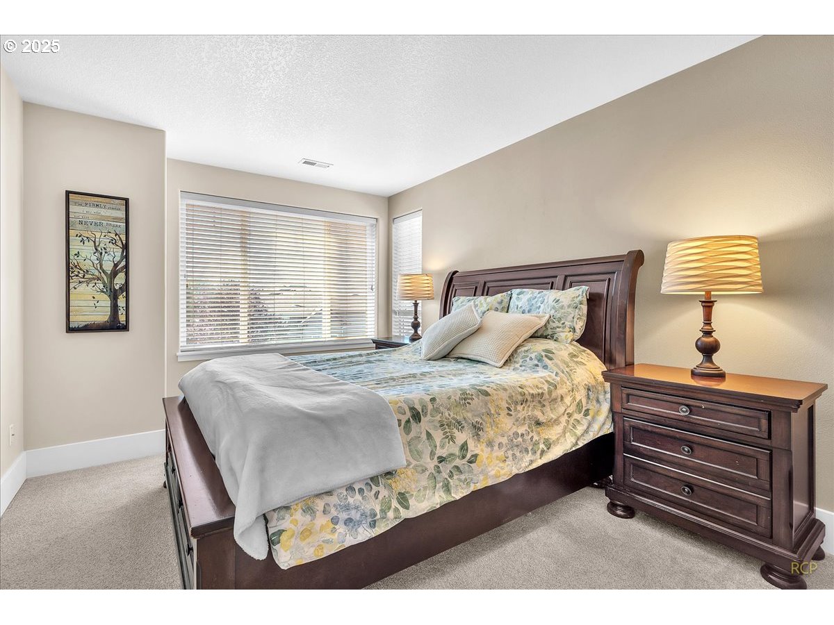 794 Northwest 118th Avenue, Unit 101 Portland, OR 97229 - Photo 23 of 41 a bedroom with a bed and a night stand