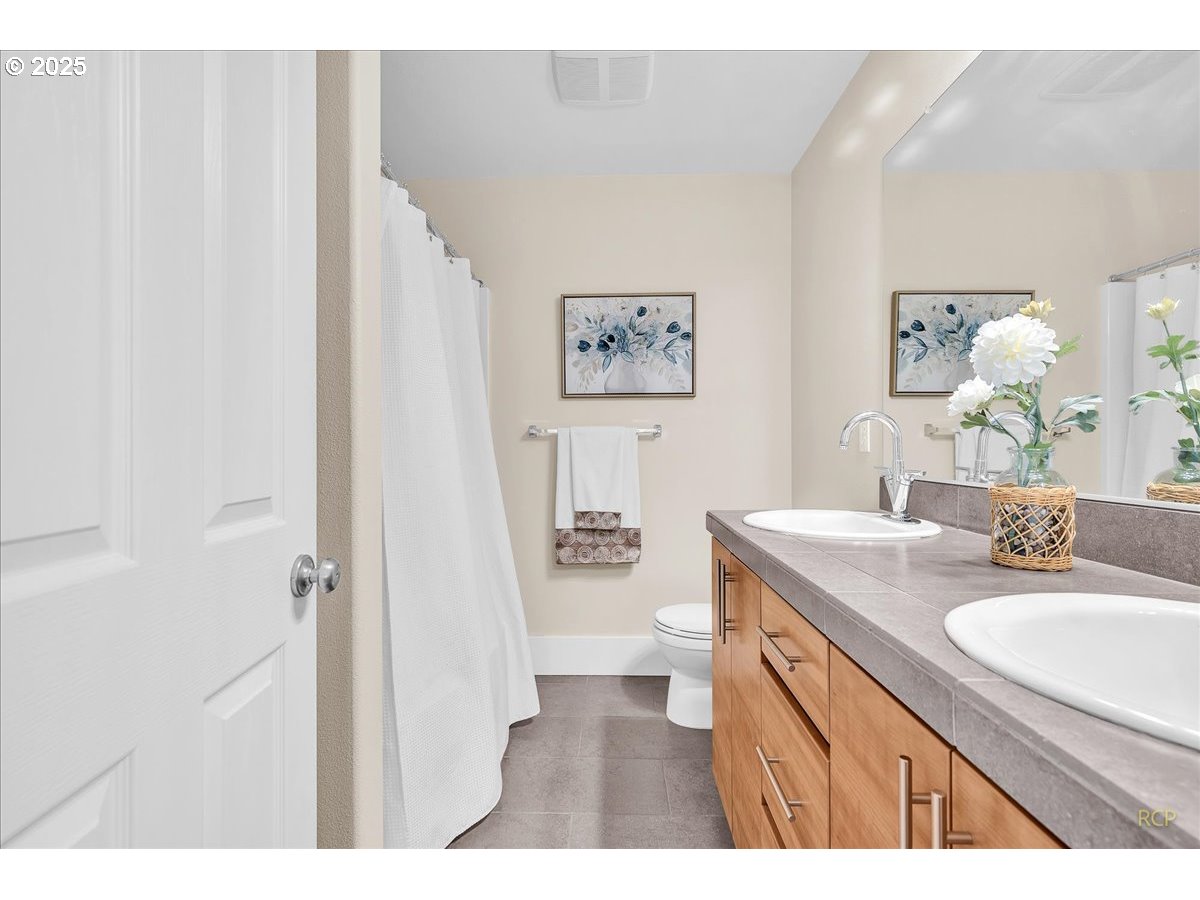 794 Northwest 118th Avenue, Unit 101 Portland, OR 97229 - Photo 25 of 41 a bathroom with a granite countertop sink a mirror and a bathtub