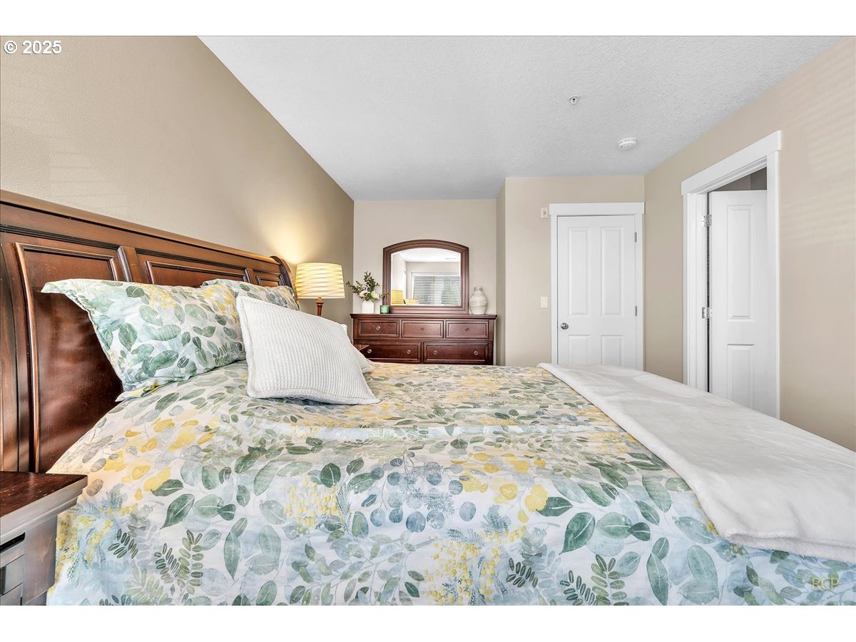794 Northwest 118th Avenue, Unit 101 Portland, OR 97229 - Photo 27 of 41 a bedroom with a bed and a dresser