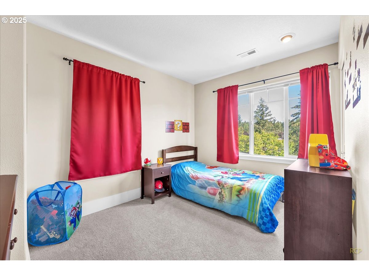 794 Northwest 118th Avenue, Unit 101 Portland, OR 97229 - Photo 28 of 41 a bedroom with a bed and window